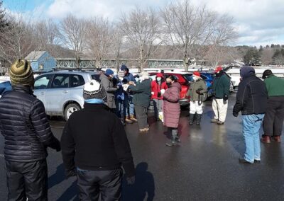 image of a group of birders meeting in the Unity Parking lot. they're wearing masks and socially distancing